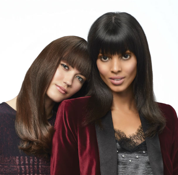 two women with long straight hair and heavy bangs