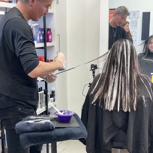 A woman getting her hair treated by a Hair Cuttery salon professional