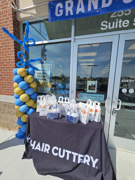 Table in front of Hair Cuttery salon with Cibu gift bags.