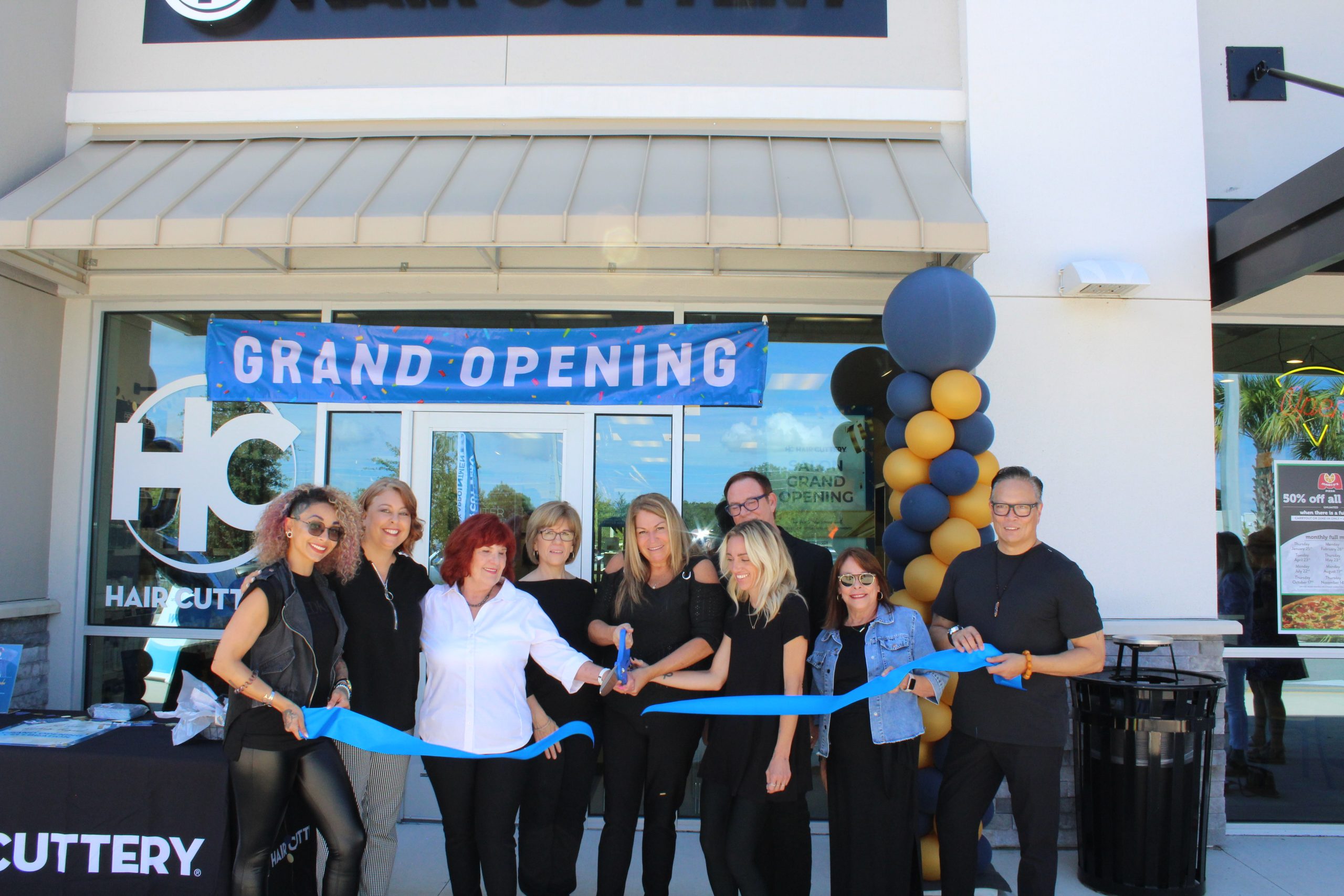 Image or ribbon cutting in front of new Hair Cuttery Salon.