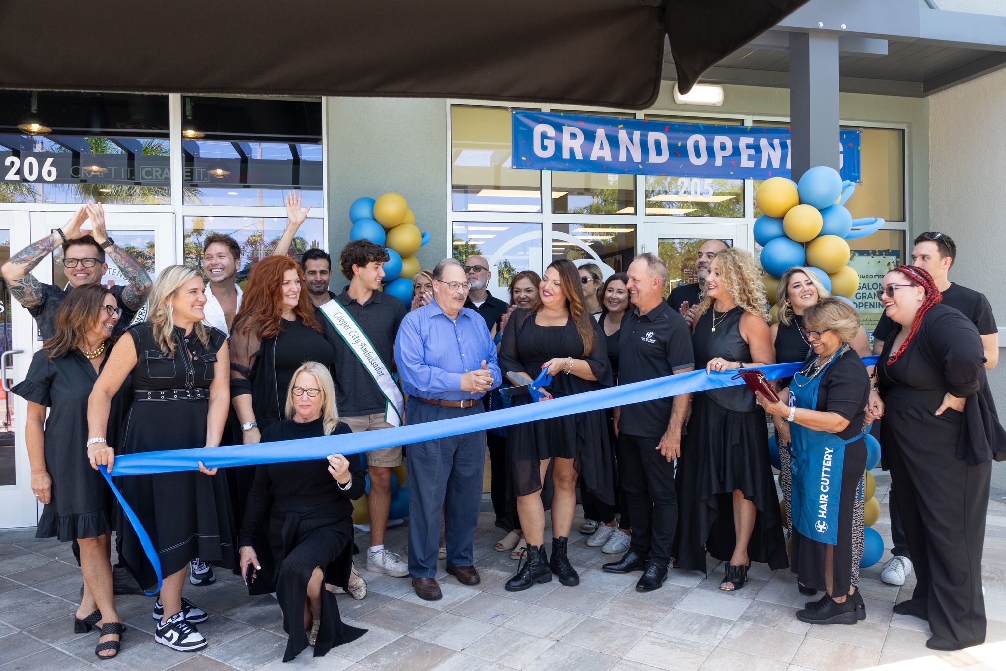 Ribbon cutting ceremony in front of Hair Cuttery salon.