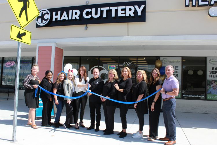 Image of ribbon cutting ceremony in front of salon.